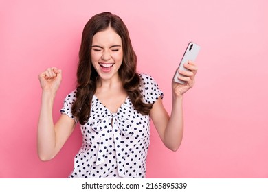 Photo of funky overjoyed girl raise fists in victory win in social media phone giveaway isolated on pink color background - Shutterstock ID 2165895339
