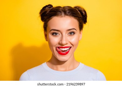 Photo of funky pretty girl dressed white shirt tongue licking lips smiling isolated yellow color background