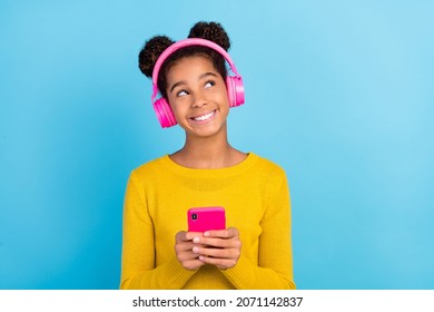 Photo of funky teen style trendy girl hold telephone look empty space wear yellow jumper isolated on blue color background - Powered by Shutterstock