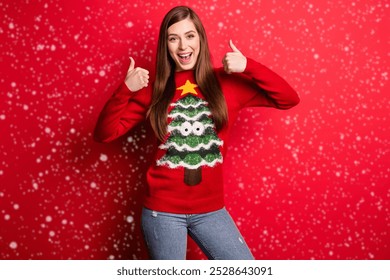 Photo of funky young lady thumb up wear holiday sweater isolated on red color background - Powered by Shutterstock