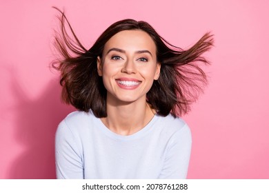 Photo of funny adorable young woman wear white sweater air blowing smiling showing teeth isolated pink color background