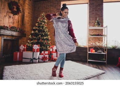 Photo of funny african lady hold hanger stylish dress enjoy present wear pullover in decorated home indoors - Shutterstock ID 2063155025