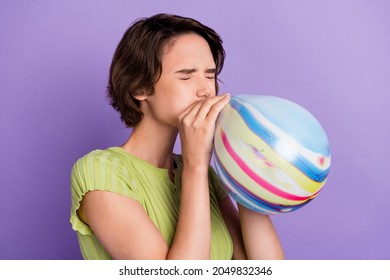 Photo Of Funny Charming Young Lady Wear Green T-shirt Bloating Colorful Balloon Closed Eyes Isolated Violet Color Background