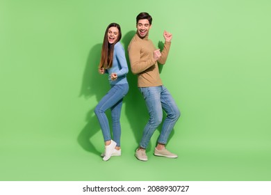Photo of funny cheerful inspired couple enjoy clubbing discotheque wear casual outfit isolated green color background - Powered by Shutterstock