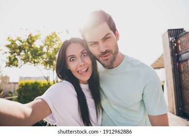 Photo of funny couple cuddle shoot selfie lady stick tongue out wear casual clothes in garden park outdoors - Powered by Shutterstock