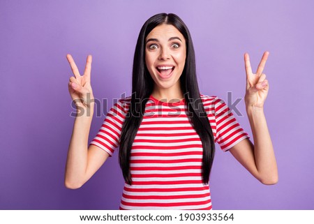 Photo of funny crazy lady raise two hands show v-sign open mouth wear striped red shirt isolated purple color background