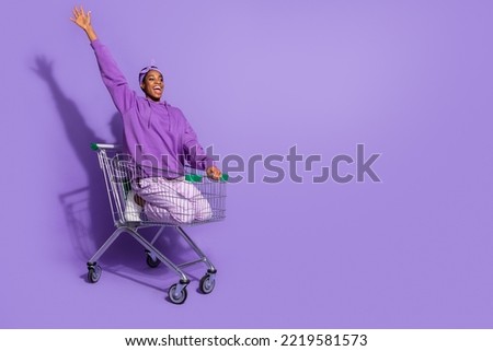 Photo of funny crazy positive transgender drive cart have fun wear headband hoodie isolated purple color background