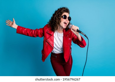 Photo Of Funny Curly Hairstyle Young Girl Sing Open Mouth Wear Round Sunglass Good Mood Isolated On Blue Color Background