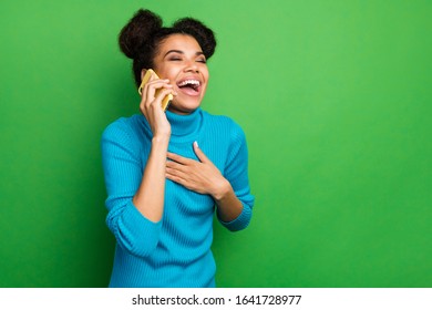 Photo Of Funny Excited Dark Skin Lady Hold Telephone Speaking Chatting With Friends Listen Humorous Story Laughing Out Loud Wear Blue Turtleneck Isolated Green Color Background