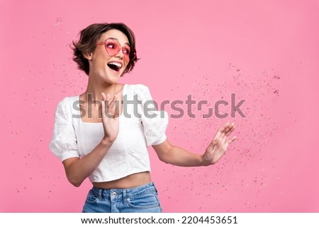 Photo of funny excited girl dressed white top heart eyewear having fun empty space isolated pink color background