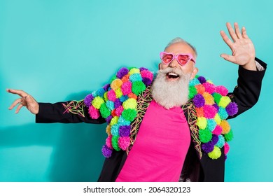 Photo of funny excited mature guy dressed craft pom-pom jacket eyewear smiling dancing isolated turquoise color background
