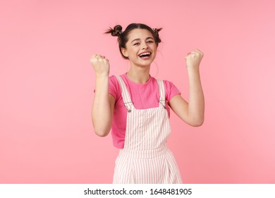 Photo of funny girl with nose ring making winner gesture and smiling isolated over pink background - Shutterstock ID 1648481905