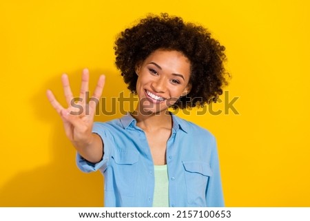 Photo of funny glad nice attractive lady teach you kid counting fingers wear denim shirt isolated yellow color background