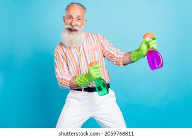 Photo of funny grandfather hold two sprayer bottle enjoy cleaning wear striped shirt isolated blue color background - Powered by Shutterstock