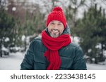 Photo of funny handsome middle age guy wear windbreaker smiling walking snowy weather outside urban city park