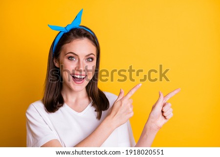 Photo of funny lady direct fingers empty space open mouth wear blue headband white t-shirt isolated yellow color background