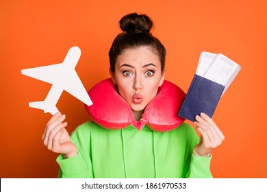 Photo Of Funny Lady Dressed Green Sweatshirt Neck Pillow Lips Pouted Holding Plane Tickets Isolated Bright Orange Color Background