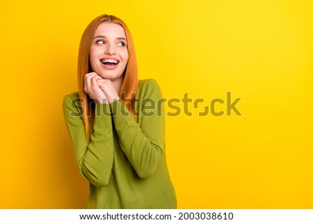 Photo of funny orange hair millennial lady hold hands look empty space wear green sweater isolated on yellow color background