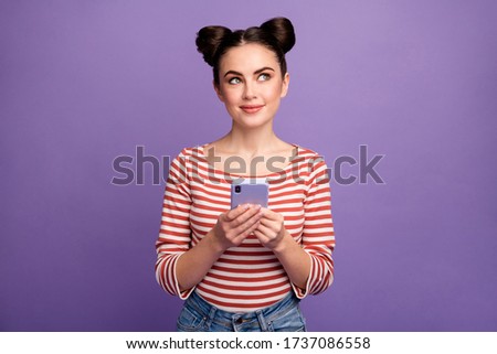 Photo of funny pretty lady hold telephone hands blogger look dreamy up empty space wait inspiration wear white red casual striped shirt isolated purple pastel color background