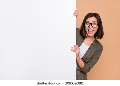 Photo of funny promoter lady hold white wall blackboard wear specs khaki shirt isolated beige color background