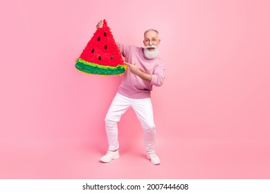 Photo of funny sweet mature man dressed pullover glasses smiling holding watermelon slice isolated pink color background