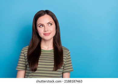 Photo of funny young brunette lady look up wear green t-shirt isolated on blue color background - Shutterstock ID 2188187463