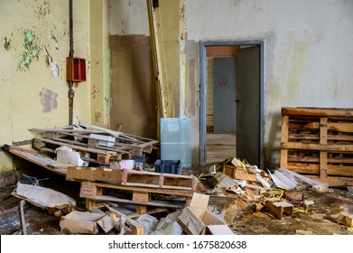 Photo of a garbage dump, dirt indoors in a slum on an abandoned building