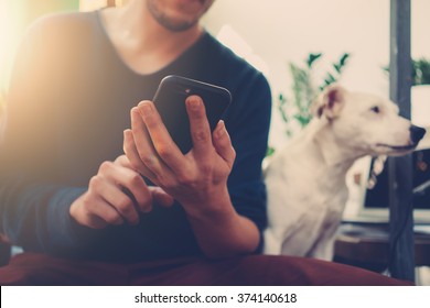 Photo of generic design smart phone holding in man hands for texting message. Blurred background