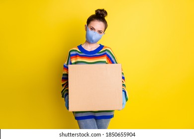 Photo of girl giving huge box wear blue mask gloves from corona rainbow sweater pants isolated on bright yellow color background
