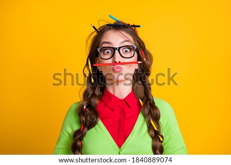 Photo of girl messy hairdo funny face expression pencil nose isolated on yellow color background