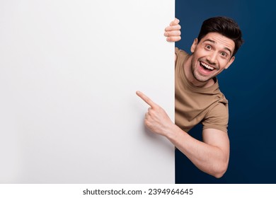 Photo of glad joyful man wear trendy clothes demonstrate benefit news cool feedback empty space isolated on dark blue color background - Powered by Shutterstock