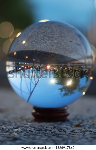 Photo of a glass\
ball of a sidewalk in a\
park