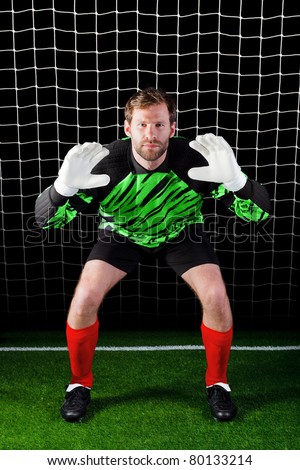 Photo of a goalkeeper facing a penalty kick, good image for concepts like Savings or Security as well as football related themes.