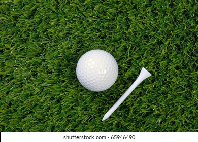 A Photo Of A Golf Ball And Wooden Tee On Grass