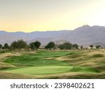 Photo of a golf course and a mountain