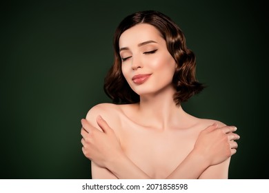 Photo of good mood beautiful attractive female hug embrace herself self-esteem isolated on green color background