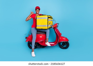 Photo Of Good Mood Confident Short Hair Human Wear Red Uniform Moped Driver Food Deliver Thumb Up Isolated Blue Color Background