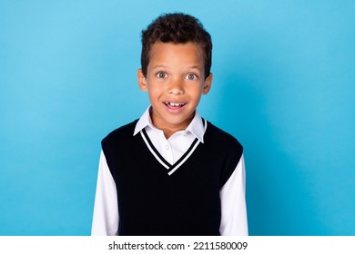 Photo Of Good Mood Excited Little Guy Dressed Black Vest Smiling Big Eyes Isolated Blue Color Background