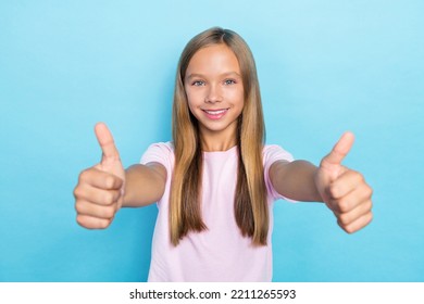Photo Of Good Mood Funny School Girl With Straight Hairdo Dressed Pink T-shirt Showing Thumbs Up Isolated On Blue Color Background