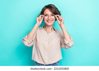 Photo of good mood gorgeous girlish woman with bob hairdo dressed beige blouse hands hold glasses isolated on teal color background