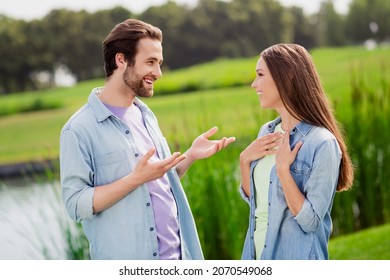 Photo of good mood positive couple married wife husband relaxing outdoors in park talking have conversation speak