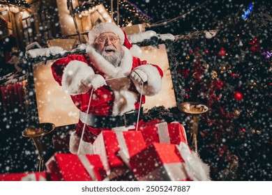 Photo of good personage santa sitting sleigh pulled by reindeer holding rope enjoying travel streets of city carrying miracle outside - Powered by Shutterstock