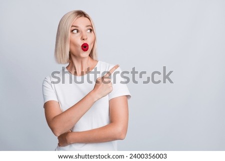 Photo of gorgeous astonished girl wear stylish clothes look empty space wow hot seasonal sale isolated on grey color background