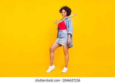 Photo of gorgeous hipster lady hold baseball bat wear denim jacket short skirt isolated yellow color background