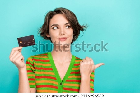 Photo of gorgeous positive girl arm hold debit card look indicate finger empty space isolated on emerald color background