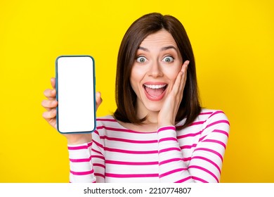 Photo of gorgeous young woman impressed hold gadget screen new app advert dressed trendy striped outfit isolated on yellow color background - Shutterstock ID 2210774807