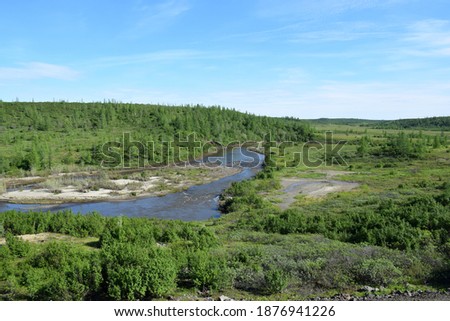 Photo of a graphic landscape resource of the mountains and terrain of the Putorana Plateau on the Taimyr Peninsula in Russia, taken in summer with a view of mountains, vegetation, undisturbed snow aga