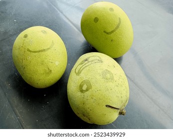 photo of a green and fresh mango with a face drawn with a wide smiling expression  - Powered by Shutterstock