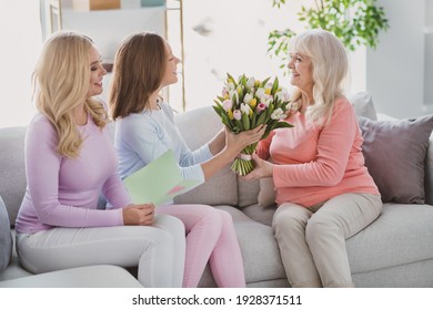 Photo Of Grey Haired Lady Mature Woman Small Girl Sit Sofa Give Flowers Gift Card Indoors Inside House