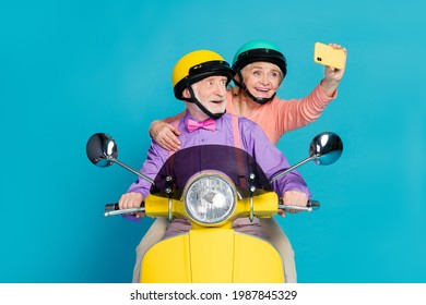 Photo of grey haired retired pensioner husband wife couple people wear helmet rider make selfie isolated on blue color background